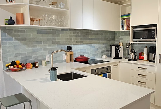 Kitchen renovation showing blue tiles and new kitchen cabinetry in Hairini, Tauranga home.