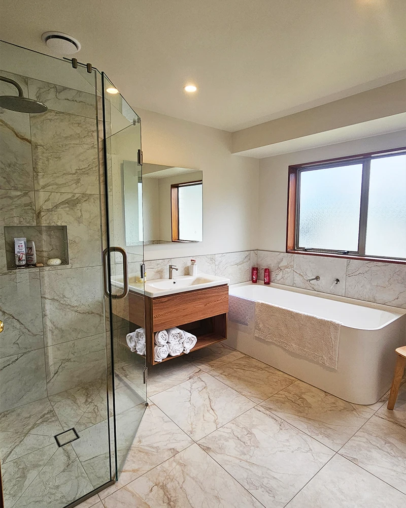 Wide view of Tauranga bathroom showing bath, vanity, and shower.