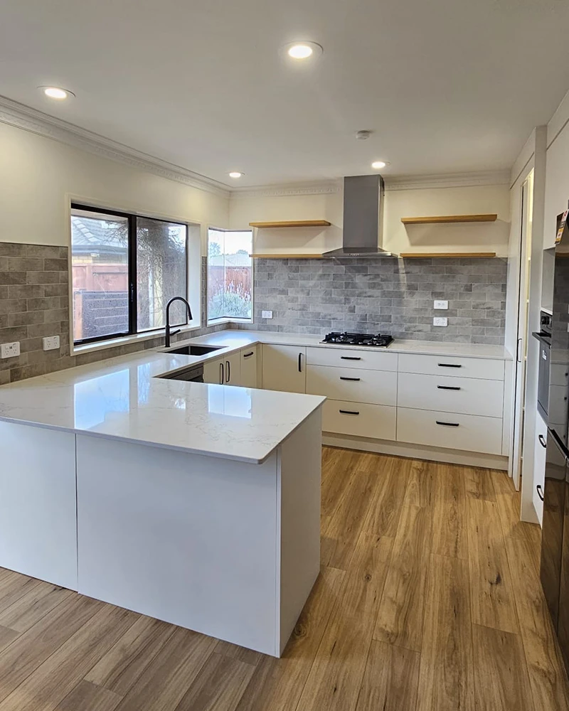 Large open kitchen with natural light and wooden floors.